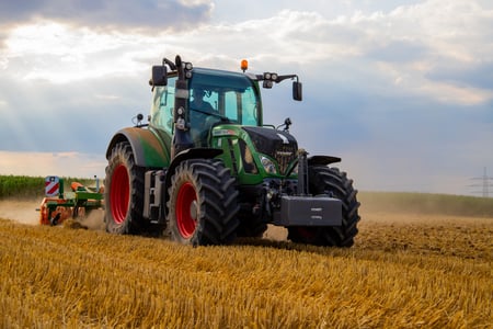 green-tractor-plowing-the-fields-on-focus-photography-2933243